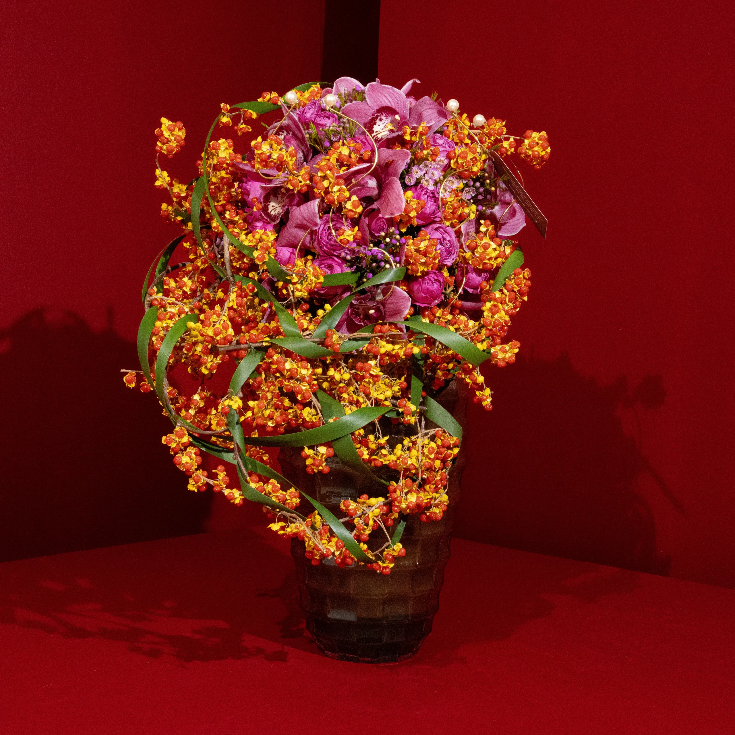 Vibrant floral arrangement against red background